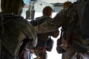 Armed men on board a helicopter