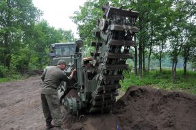 The sapper manages the earth-moving machine