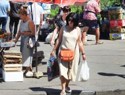 Женщина несет пакеты с продуктами