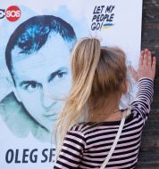 Participants of the action in support of Oleg SentsovA little girl near the stooge with a portrait of Oleg Sentsov