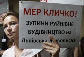 Активістка тримає плакат 