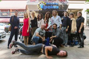 Participants of the presentation are photographed in front of the cinema "Ukraine"