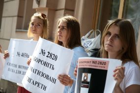 Participants of the action hold posters