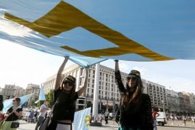 People keep the national flag of the Crimean Tatars