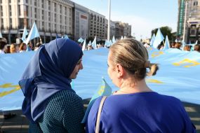 People keep the national flag of the Crimean Tatars