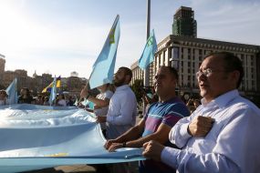 People keep the national flag of the Crimean Tatars
