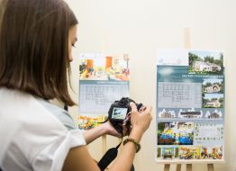 The girl takes a photograph of the project