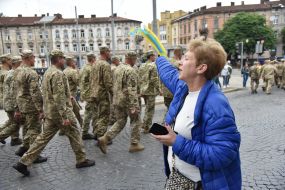 A woman welcomes servicemen
