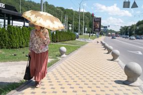 The woman goes under an umbrella