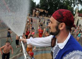 The man is pouring water on people