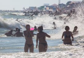 Vacationers are bathed in the sea.