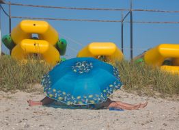 Resting under a beach umbrella