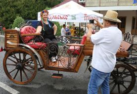 A man is taking pictures of his companion in a carriage