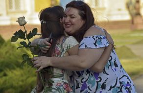Participants of "Flash mob of femininity" embrace