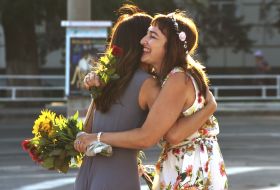 Participants of "Flash mob of femininity" embrace