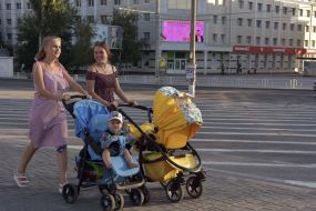 Young mothers are taken in children's strollers