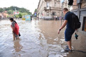 Passers-by in a flooded street