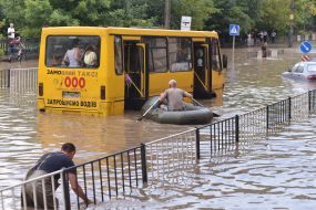 A man on a boat near a minibus