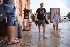 Passers-by in a flooded street