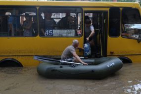 A man on a boat near a minibus