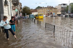 Passers-by in a flooded street