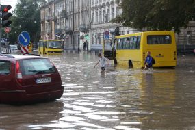 The boys cross the flooded street