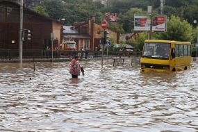 The boys cross the flooded street
