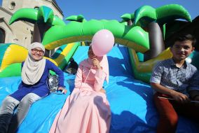 Children sit on an inflatable trampoline