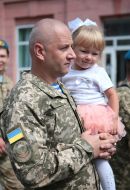 Serviceman with a girl on her hands