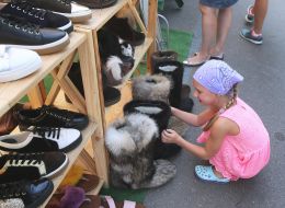 The girl looks at the boots