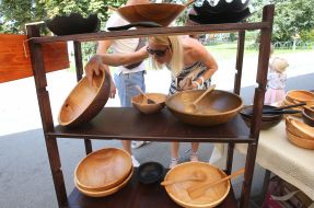 A woman chooses a wooden tableware