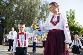Schoolchildren with a bell in their hands
