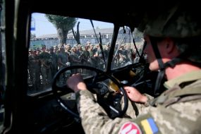 Army Reserve Army Commander at the helm of a military vehicle