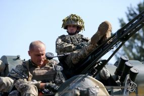 Army servicemen-reserveists of the Armed Forces on the armored personnel carriers