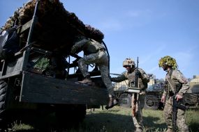 Soldiers-Reservists of the Armed Forces sit in a truck