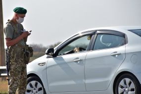 Border guard in a gauze bandage checks the car