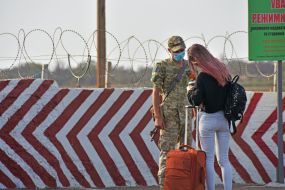 Border guard in the gauze bandage checks documents