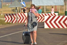 A woman covers her face with a handkerchief