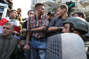 Participants of the action, chained to the fence near the AP
