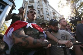 Participants of the action, chained to the fence near the AP