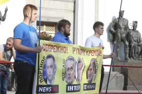 Participants of the action hold a poster