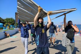Activists demolish the fence at the construction site
