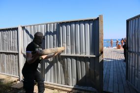 Activists demolish the fence at the construction site