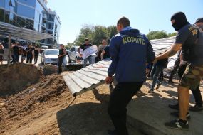 Activists demolish the fence at the construction site