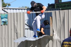Activists demolish the fence at the construction site