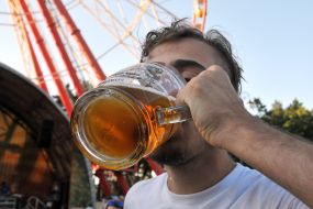 A man with a glass of beer