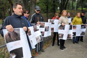 Residents of the hostel UTOS hold the posters