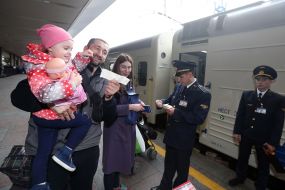 The Explorer checks tickets for passengers at the train carriage
