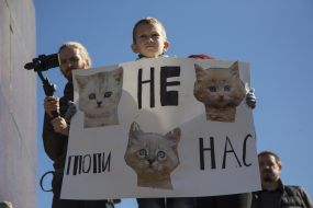 The boy is holding a poster