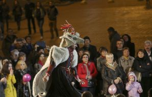 Actor in a theatrical costume of a goat on a podium